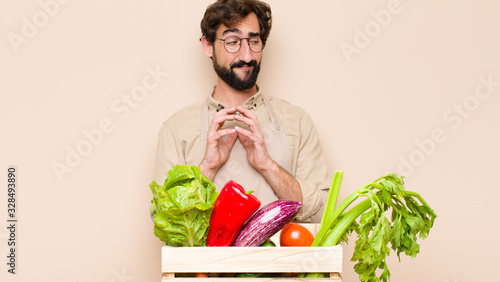 Fotografie green grocery man feeling proud, mischievous and arrogant while scheming an evil
