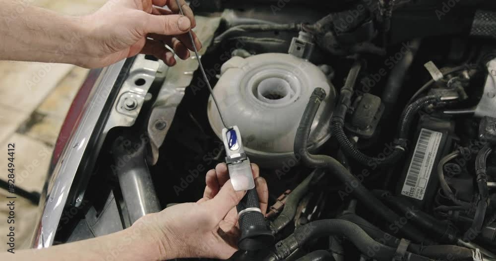 Car Mechanic Checking Antifreeze In The Car. Antifreeze Test Car Mechanic Checking Antifreeze In The Car. Antifreeze Test