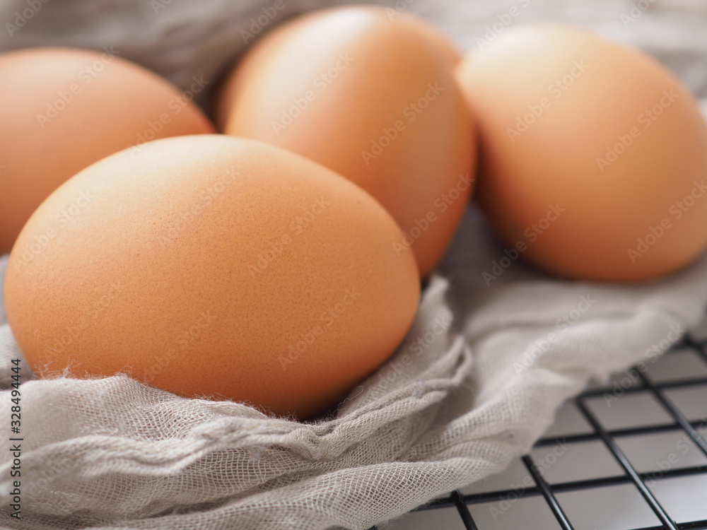 Organic chicken eggs, fresh from the farm put on gray fabric. High in protein, Close up with copy space. Organic chicken eggs, fresh from the farm put on gray fabric. High in protein, Close up with copy space.