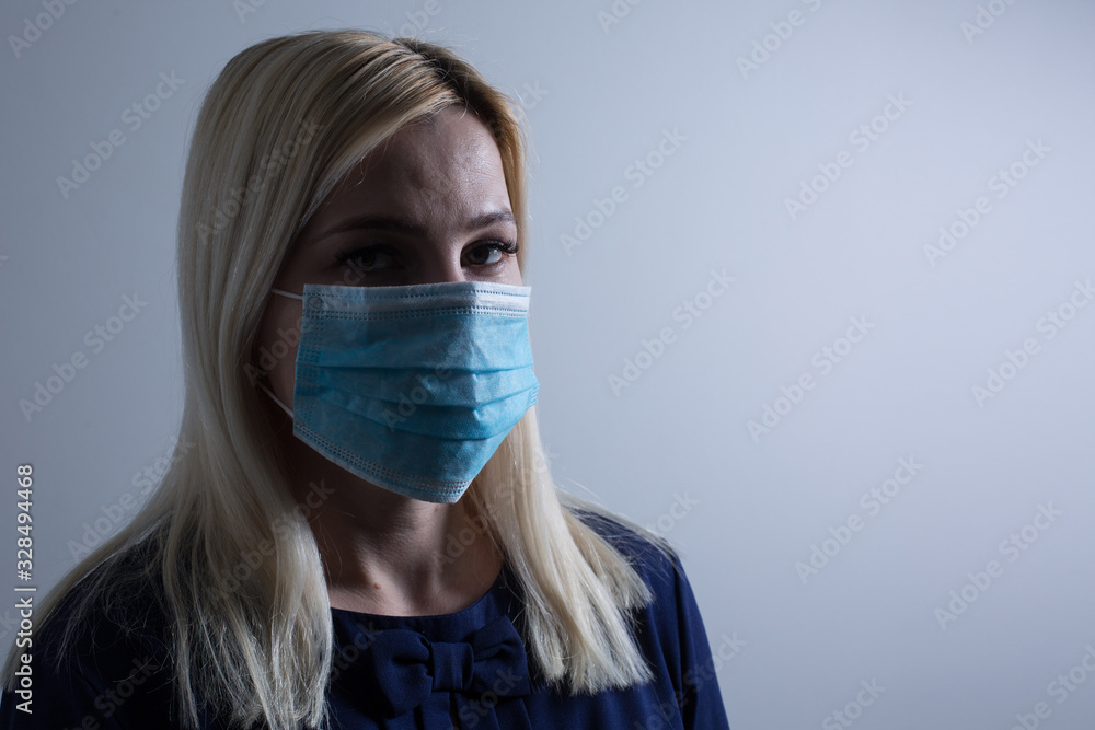 Young long-haired woman in protective medical mask Young long-haired woman in protective medical mask