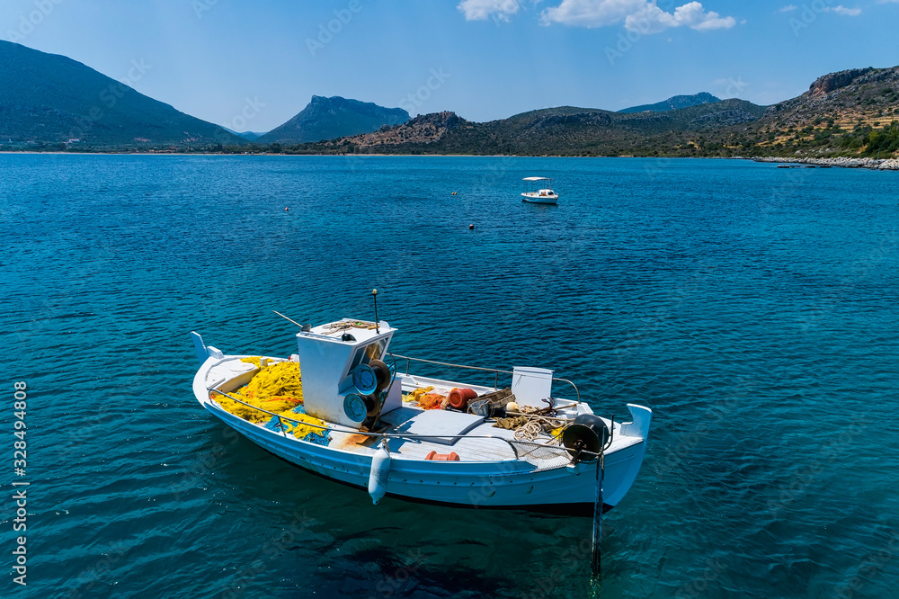 Aerial photo top view of small traditional fishing boat in tropical emerald and turquoise clear sea Aerial photo top view of small traditional fishing boat in tropical emerald and turquoise clear sea