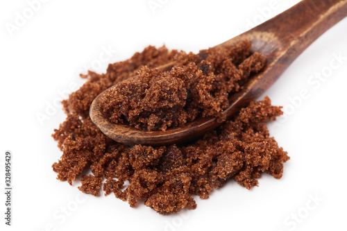 Dark muscovado sugar, also called Barbados sugar, khandsari, or khand, isolated on white background photo