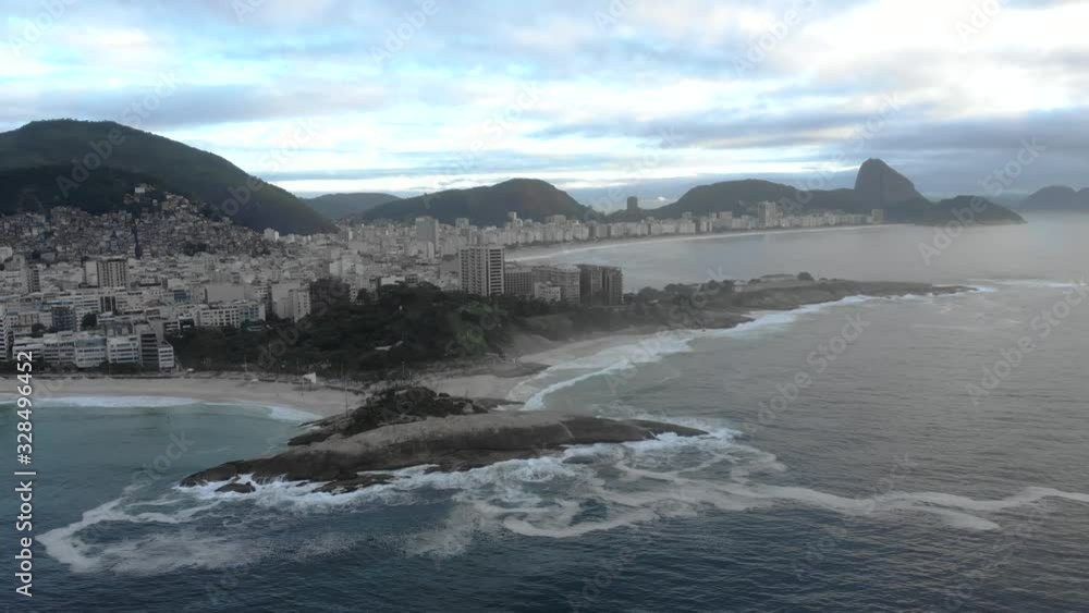Early morning sideways aerial pan showing Arpoador and Copacabana fort in the foreground and the Sugarloaf mountain in the background revealing Corcovado and Two Brothers mountains Early morning sideways aerial pan showing Arpoador and Copacabana fort in the foreground and the Sugarloaf mountain in the background revealing Corcovado and Two Brothers mountains