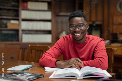 Obraz na plátne Happy university student in library