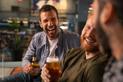 Friends enjoying beer at pub photo