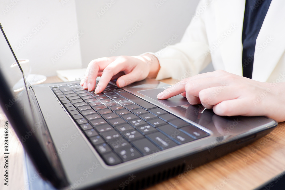 Cropped shot view of business woman’s hands typing the labtop with blank copy space screen for your information content or text message. Cropped shot view of business woman’s hands typing the labtop with blank copy space screen for your information content or text message.