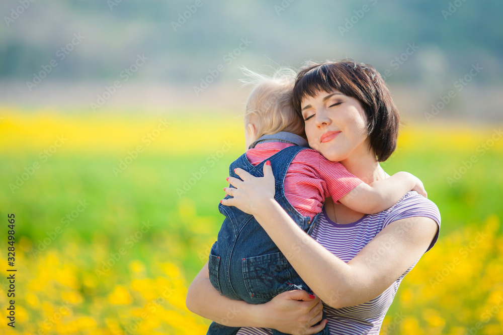 Happy woman and child in the blooming spring garden. Happy woman and child in the blooming spring garden.