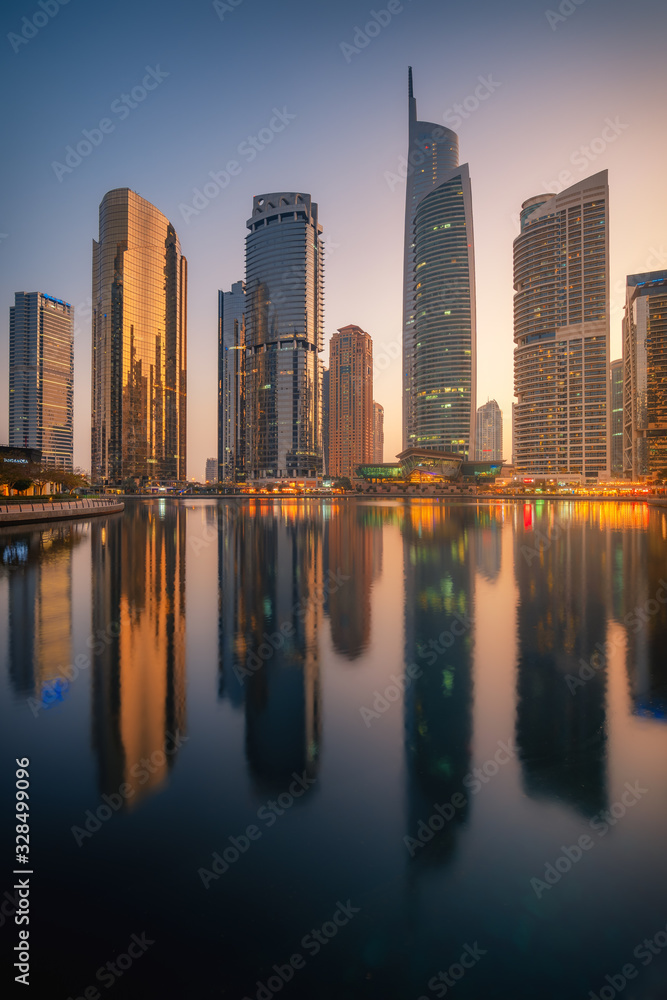 Amazing architecture parallel buildings. Cloudy night sky. Luxury travel inspiration. Dubai Jumeirah Lake Towers.