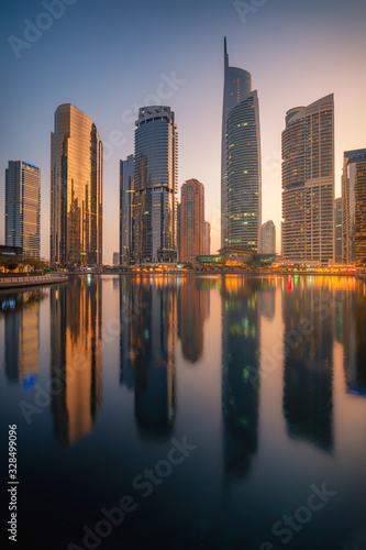 Amazing architecture parallel buildings. Cloudy night sky. Luxury travel inspiration. Dubai Jumeirah Lake Towers. © Evgeni