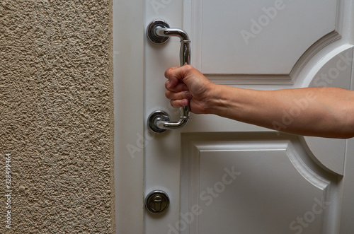 Hand holding a door handle