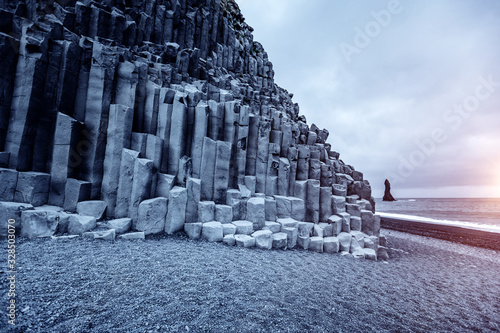 A unique rock on the Atlantic Ocean. Location Reynisfjara Beach, Iceland, Europe. photo