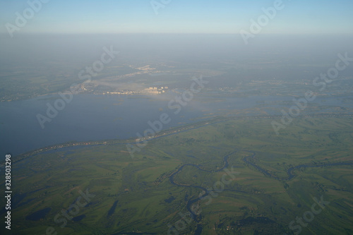 Obraz na płótnie View from the plane window to the clouds and the earth w salonie