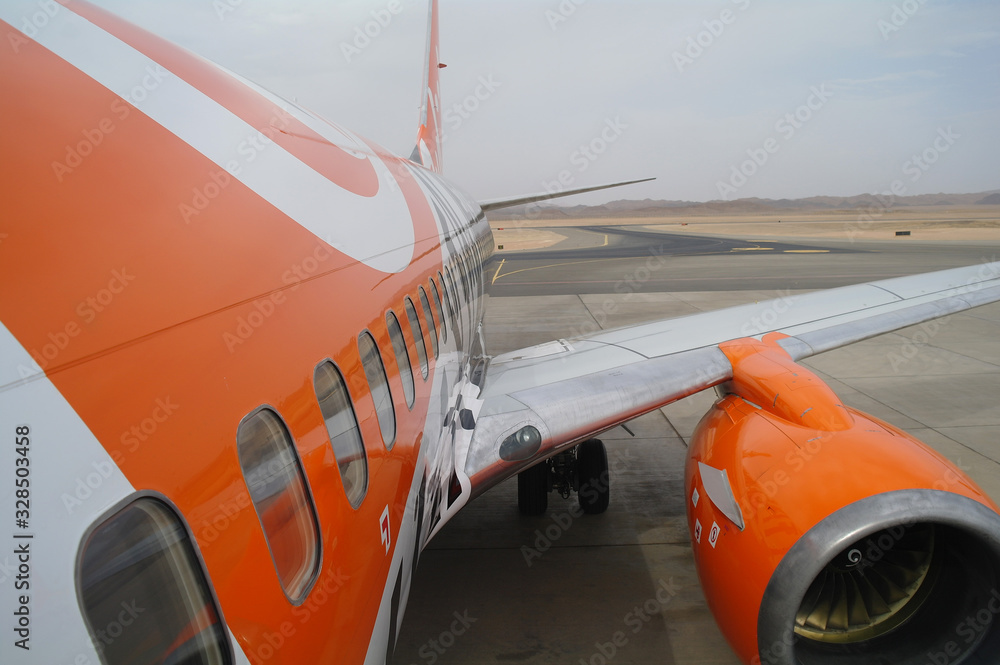 Close up of airplane jet engine parked at an airport apron