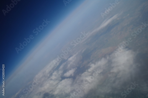 Obraz na płótnie View from the plane window to the clouds and the earth w salonie