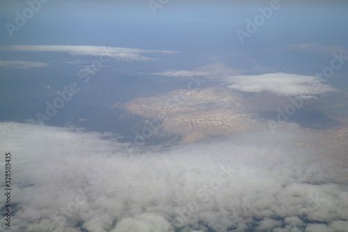 Obraz na płótnie View from the plane window to the clouds and the earth w salonie