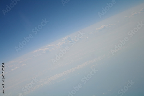 Obraz na płótnie clouds and blue sky seen from plane w salonie