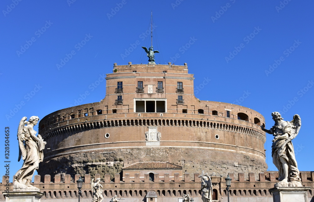 Castel Sant’Angelo and marble angels from Ponte Sant'Angelo with blue sky. Rome, Italy.