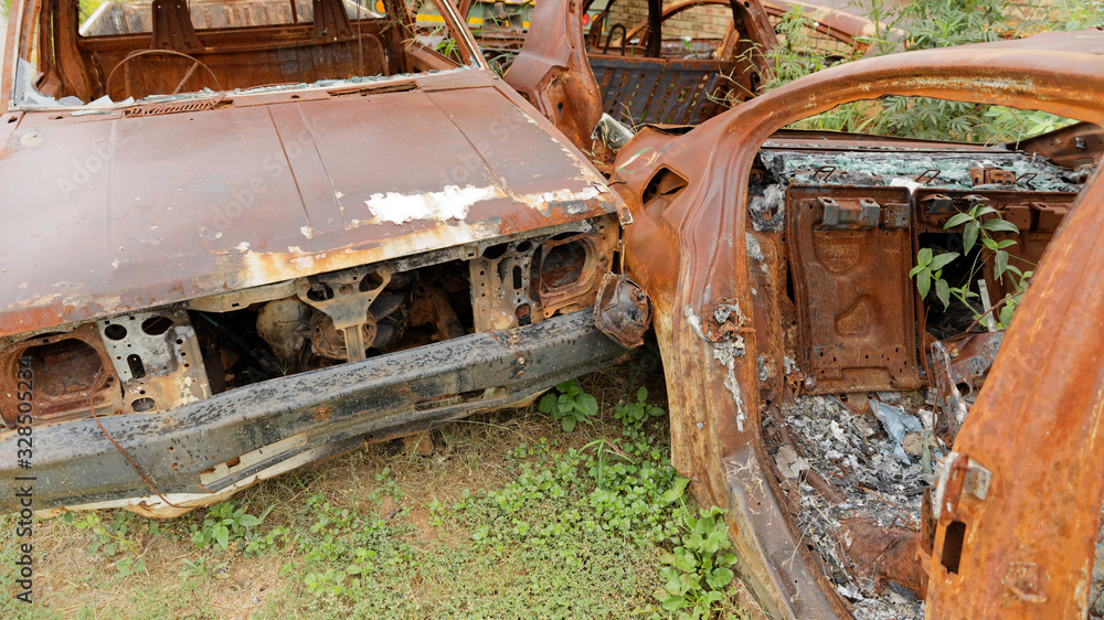 Abandoned burnt out rusty cars