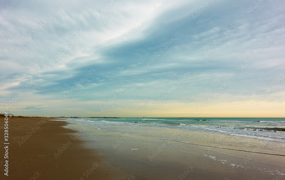 Wide sandy beach in Rimini and clouds