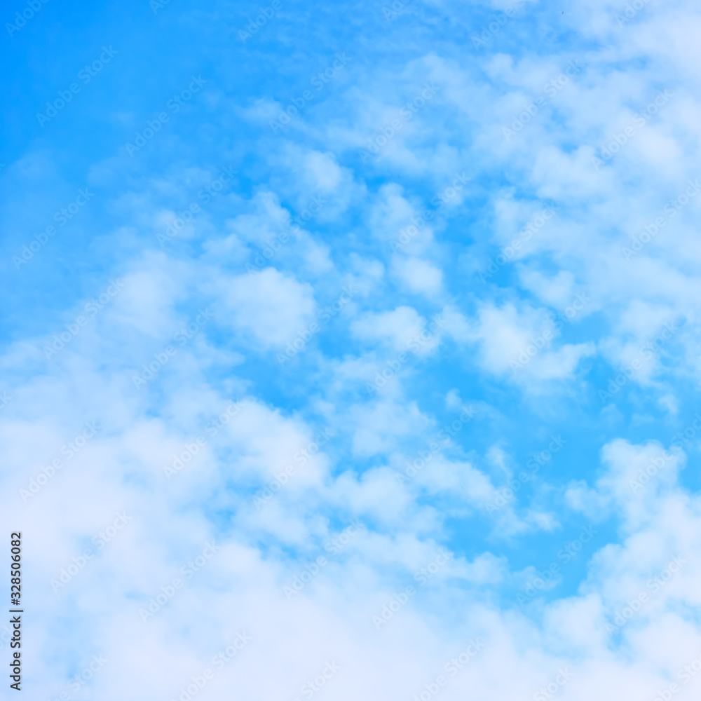 Blue sky with small white fleecy cloud