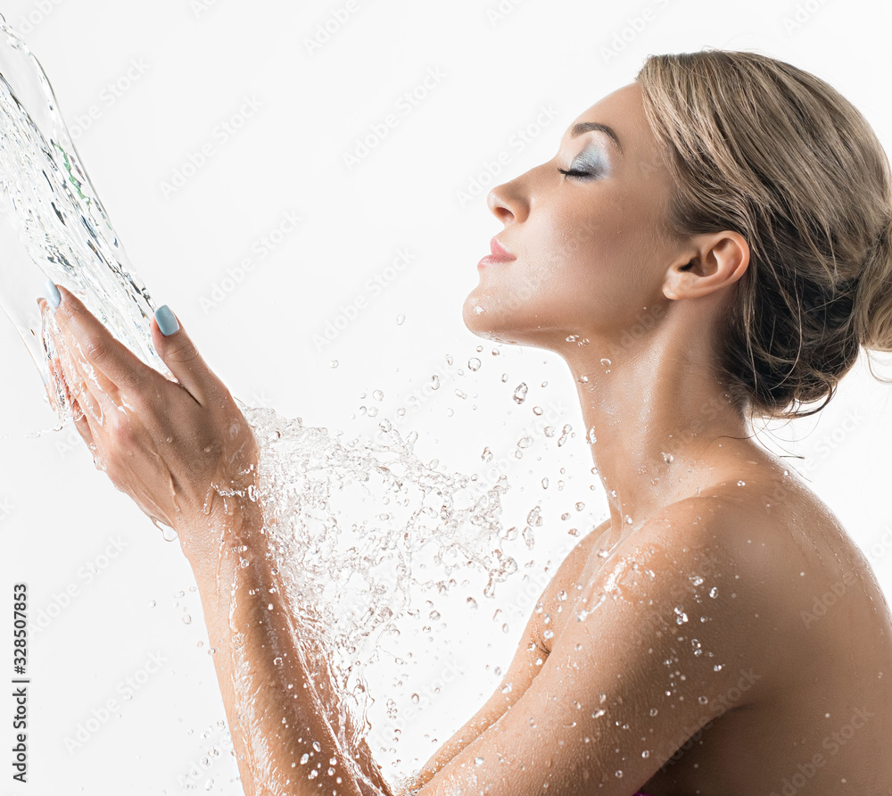 Pretty girl catching water stream in her hands Pretty girl catching water stream in her hands