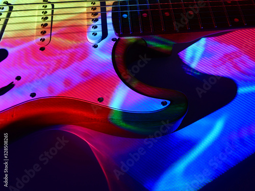 Photography electric guitar closeup in the color stage light