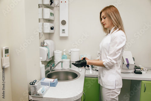 the dentist has finished the procedure and washes his hands in the sink