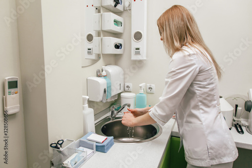girl doctor beautician washes hands