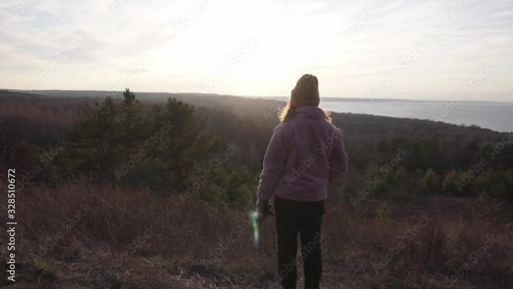 Female looking at the epic valley and sea view Female looking at the epic valley and sea view