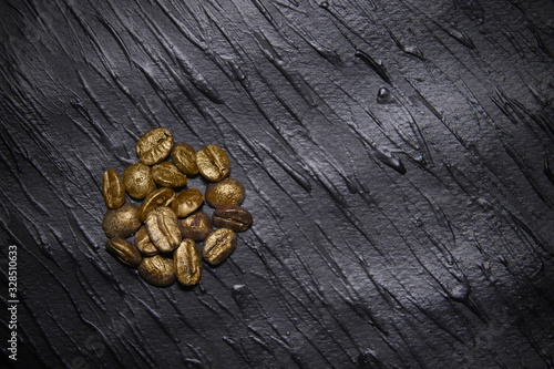golden coffee seeds on black texturegolden coffee seeds on black texture