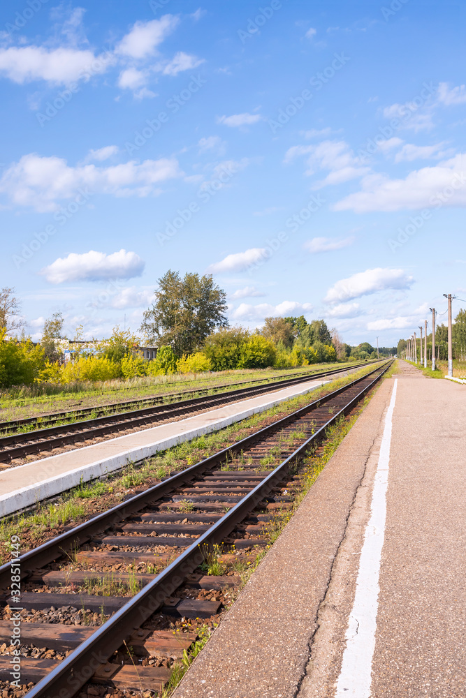 Fototapeta premium Railroad tracks and platform in the countryside