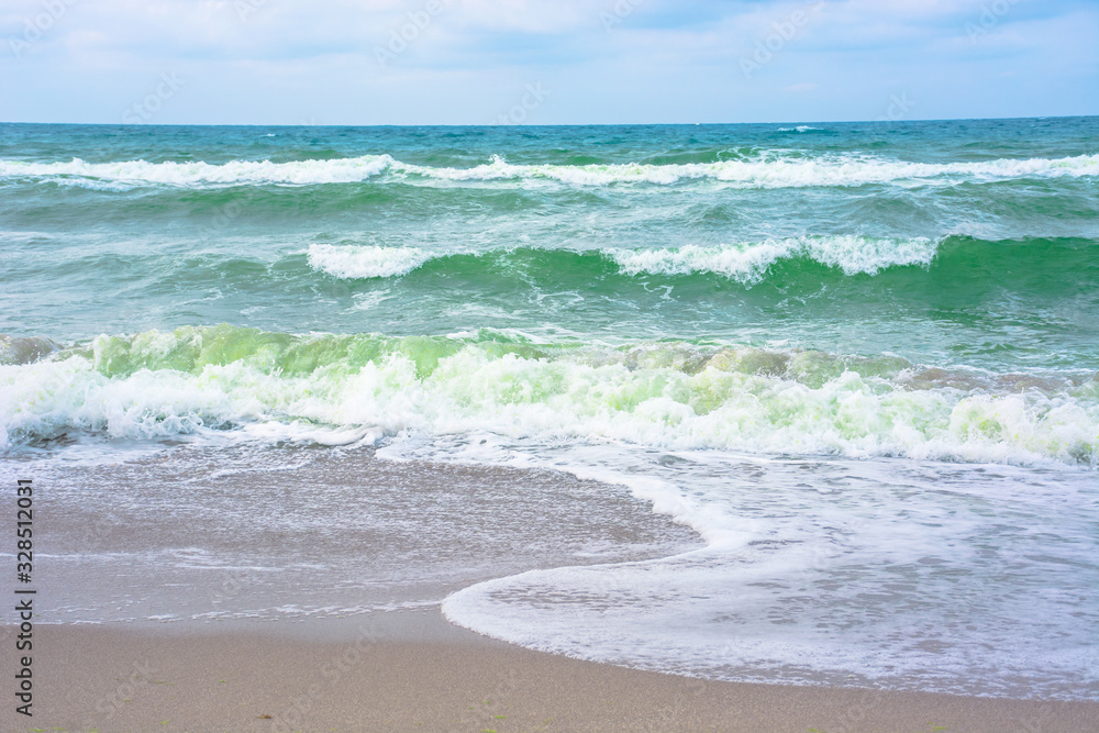 waves crash on sandy beach waves crash on sandy beach