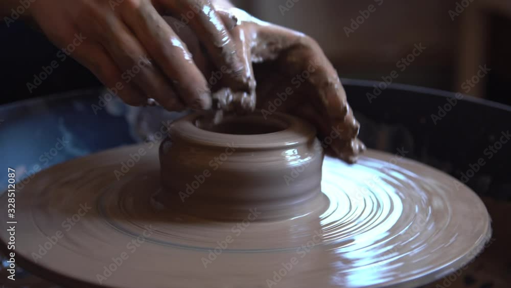 Woman working with clay in pottery workshop. Woman working with clay in pottery workshop.