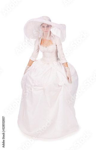 Portrait of a charming girl in a white dress in retro style, the bride in a retro dress.