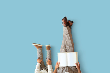 Father and young son sit and read a book