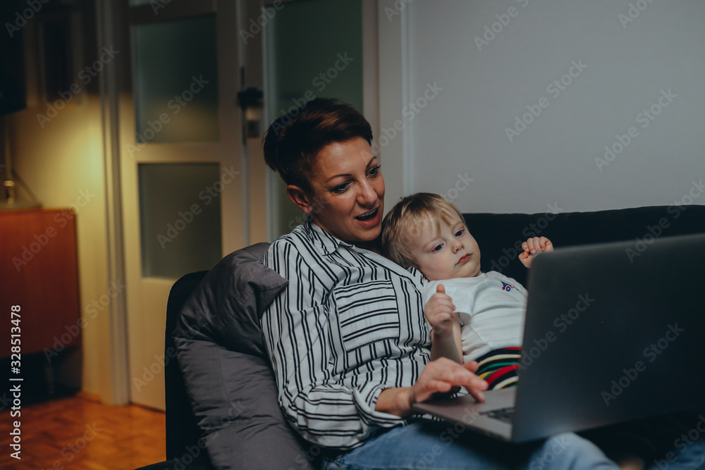 mother and her little boy using laptop at home mother and her little boy using laptop at home