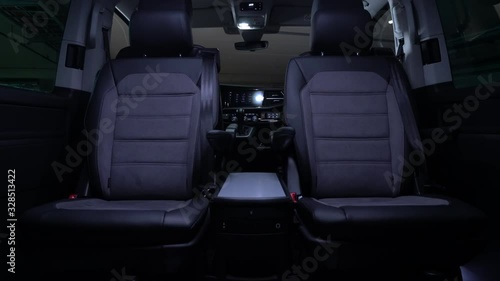 Luxury leather seats in the comfortable van. Interior of luxury minivan with backlight, transfer car