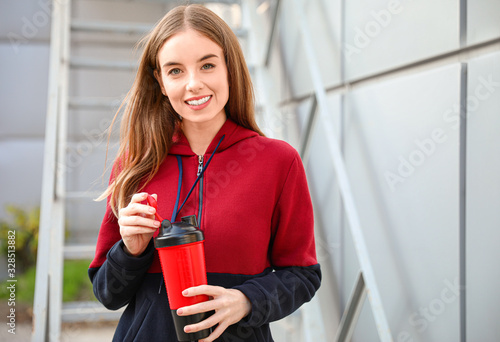 Young sporty woman with pro...