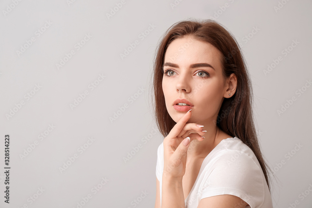Young woman with beautiful makeup on light background Young woman with beautiful makeup on light background
