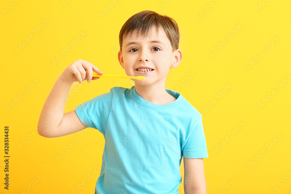 Cute little boy with tooth brush on color background Cute little boy with tooth brush on color background