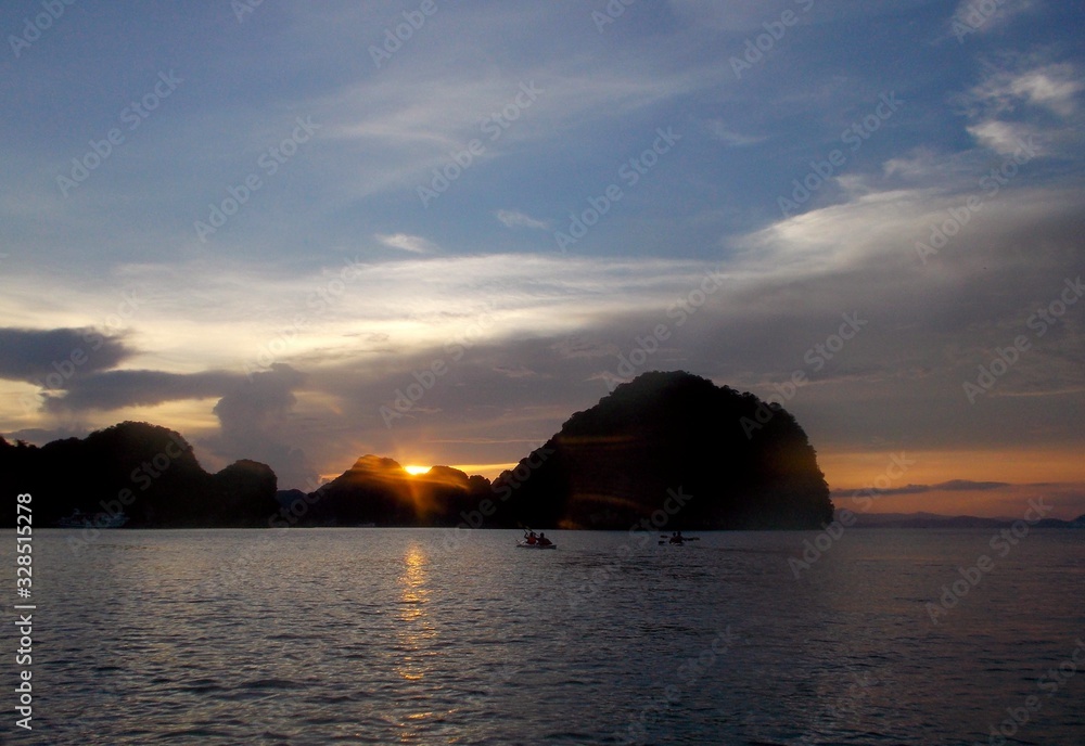 Canoes in the sunset at Halong Bay