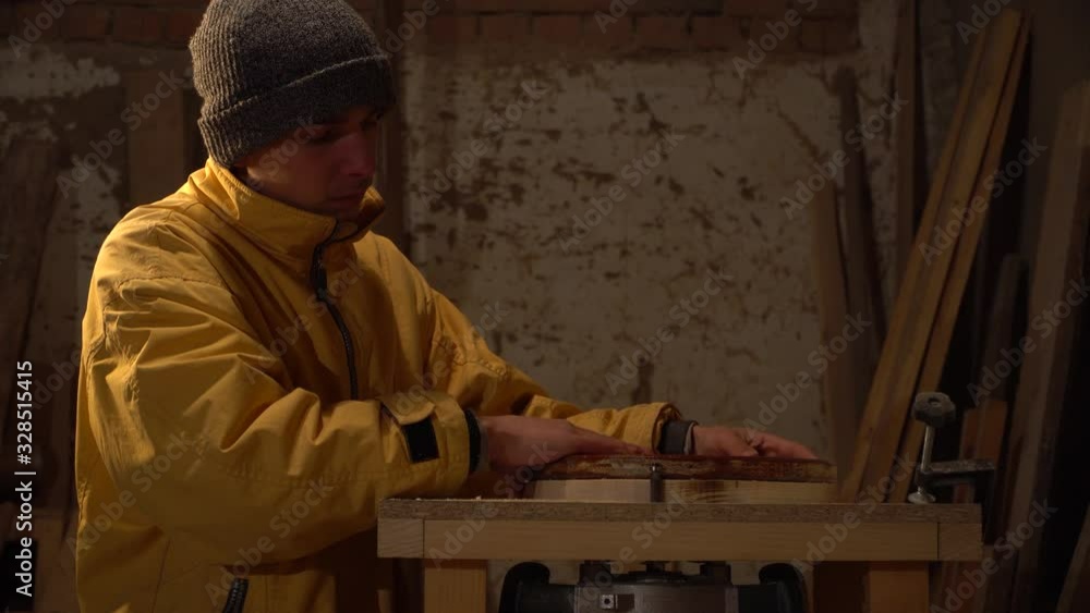Hands craftsman in furniture industry production.Wood processing. Man works in furniture industry.Young guy working in his workshop Hands craftsman in furniture industry production.Wood processing. Man works in furniture industry.Young guy working in his workshop