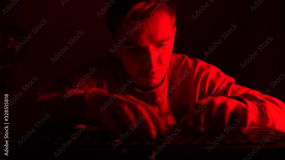 Crazy hacker is working on a computer. A strange man is breaking a computer Crazy hacker is working on a computer. A strange man is breaking a computer