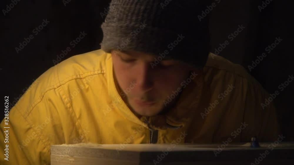 The guy is a carpenter blowing wood dust from the work surface.Slow motion The guy is a carpenter blowing wood dust from the work surface.Slow motion