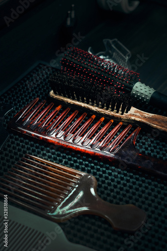 Hairbrushes in a barber shop on a black table. Hair styling. Professional barber tools. © Дмитрий Ткачев