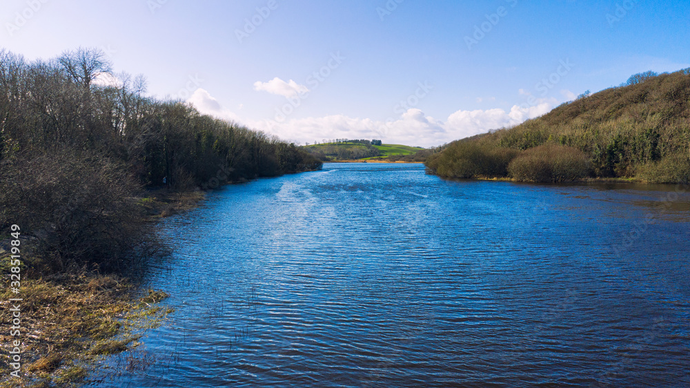 Naklejka premium aerial view of sunny quoile river winter countryside in Downpatrick,Northern Ireland