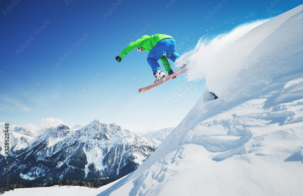 Jumping skier in alpen mountains. Freeride fun in fresh snow.