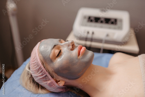 Young woman visiting cosmetologistUltrasonic Skin Cleansing Procedure. Beauty Treatment. Cosmetology. Beauty Spa Salon.