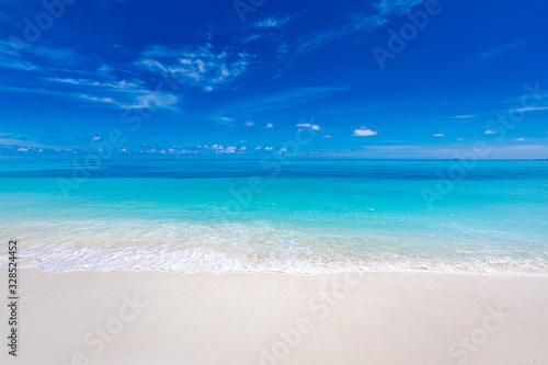 Summer beach and sea. Tropical pattern with blue sky and calm waves splashing. Exotic nature backdrop  coastline and beach