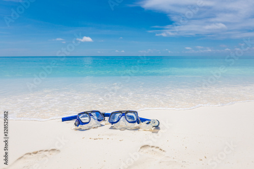 Fototapeta Naklejka Na Ścianę i Meble -  Summer sport, beach activity, beach recreational concept. Diving goggles and snorkel gear on white sand near beach. Summer vacation and recreational travel background
